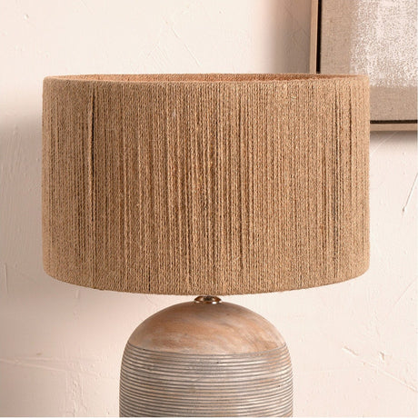 Issa Rope Cylinder Lampshade in natural jute, 45cm wide, shown on a wood and ribbed ceramic base lamp against a light neutral wall.