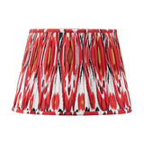 Izara Red Ikat Pleated Tapered Lampshade, 35cm, in a bold red, black, white and gold ikat pattern fabric with pleated fabric sides, shown on a plain white background.