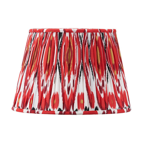 Izara Red Ikat Pleated Tapered Lampshade, 35cm, in a bold red, black, white and gold ikat pattern fabric with pleated fabric sides, shown on a plain white background.