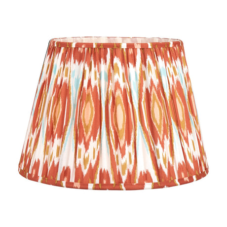 Izara Cinnamon Ikat Pleated Tapered Lampshade, 40cm, in a gathered fabric with rust, gold and pale blue ikat pattern, shown on a plain white background.