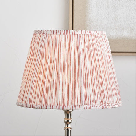 Thiago Cinnamon Stripe Pleated Tapered Lampshade, 30cm, in cinnamon and white fabric on a chrome table lamp base, shown against a light neutral background.