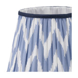 Close-up of the Kamilah Blue Chevron Pleated Tapered Lamp Shade, 25cm, showing blue and white zigzag fabric with gathered pleats and a navy trim edge.