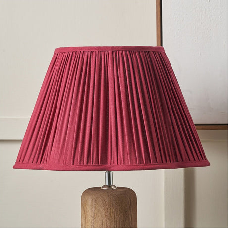 Malia Mulberry Red Pleated Tapered Lamp Shade, 35cm, fabric shade on a wooden table lamp base with chrome fitting, shown against a plain light background.