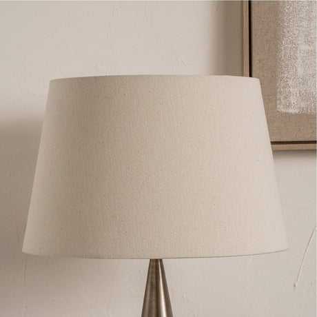 Coast Cream Calico Tapered Lampshade in linen fabric, 40cm wide, shown fitted on a table lamp with tapered drum shape against a neutral wall.