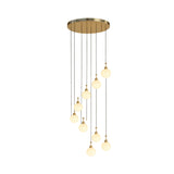 Niori Lorixa 9 light cascading chandelier with alabaster globes on brushed bronze caps, suspended at staggered heights from a round canopy.