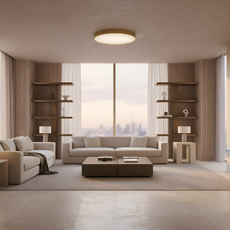 A modern minimalist living room with two beige sofas, a central coffee table, open shelving, and a Bravion LED Small Round Alabaster Flush Ceiling Light in Soft White & Brushed Brass. Floor-to-ceiling windows offer sunset city views.
