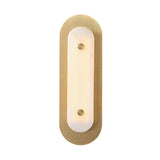 The Avelora LED Large Capsule Alabaster Wall Light features an oval shape, soft white frosted central panel, brass perforated outer frame, and two round brass accents, mounted vertically for a modern look.