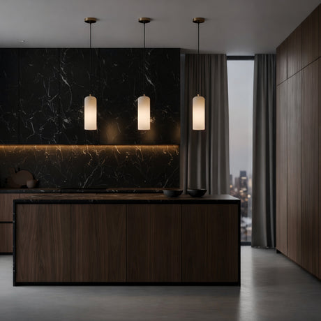 A modern kitchen featuring dark wood cabinets, a black marble backsplash, and three Velmora 1 Light Slim Cylindrical Alabaster Single Pendant Lights in soft white & brass above the island. Floor-to-ceiling curtains frame a city view for a minimal, elegant space.