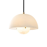 The Elvara 1 Light Bowl Alabaster Single Pendant Light features a smooth soft white dome shade and brushed brass accents, elegantly suspended by a black cord against a plain white background.