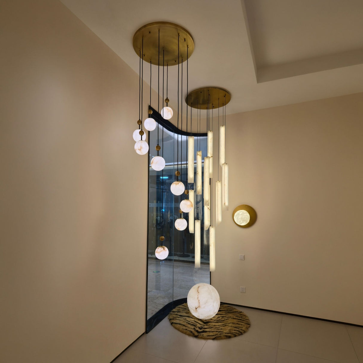 Orlena 3 Light Globe Alabaster Floor Lamp with veined white sphere on copper base, part of a ceiling pendant cluster in a living room setting.