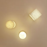 Bravora semi-flush ceiling lights in alabaster with brushed brass canopies, shown illuminated in round and square forms against a warm neutral wall.