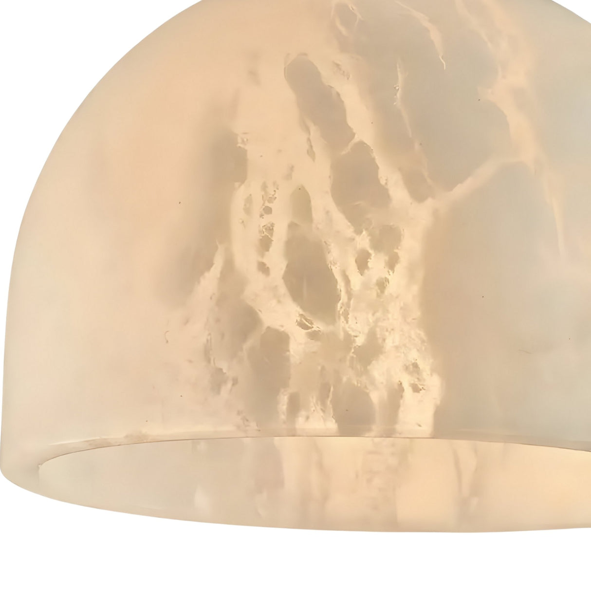 A close-up of the Belvix 1 Light Large Dome Alabaster Single Pendant Light in soft white and brushed brass, featuring a marbled alabaster shade that gently diffuses light.