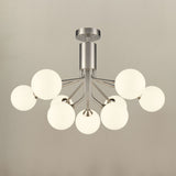 Semi-flush ceiling light with eight brushed nickel arms holding matt opal glass globe shades, shown illuminated against a plain light grey background.
