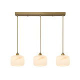The Vantor 3 Light Linear Alabaster Bar Pendant Light in soft white and brushed brass features three alabaster shades suspended from a rectangular brushed brass base, giving any space a modern touch.