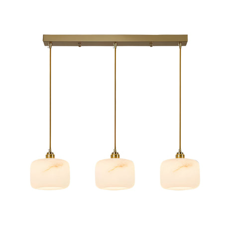 The Vantor 3 Light Linear Alabaster Bar Pendant Light in soft white and brushed brass features three alabaster shades suspended from a rectangular brushed brass base, giving any space a modern touch.