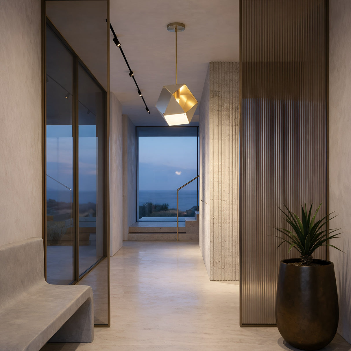 A modern, minimalist hallway with light walls and floors features the Spar Single Pendant Light in white & gold, a frosted glass divider, potted plant, and a large window at the end framing ocean and sky views.