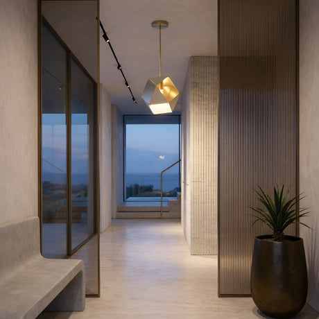A modern, minimalist hallway with light walls and floors features the Spar Single Pendant Light in white & gold, a frosted glass divider, potted plant, and a large window at the end framing ocean and sky views.