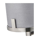 Close-up of the Midland wall light's grey fabric drum shade and brushed nickel bracket detail, showing metal joinery and finish against the shade.