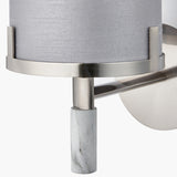 Close-up of the Midland wall light showing the brushed nickel ring and support arm, grey fabric shade, and marble effect column base.
