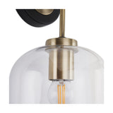 Close-up of the Florence Black Iron & Glass Wall Light showing the antique brass fitting, clear glass dome shade and exposed filament bulb, with black wall mount above.