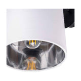 Close-up of the Elin Matt Black & Ivory Wall Light showing the ivory fabric shade with mirrored chrome interior and visible bulb, mounted on a matt black wall bracket.