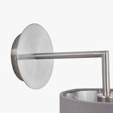 Close-up of the Elin wall light in brushed silver, showing the round wall plate, straight arm, and angled fitting above a grey fabric shade on a plain white background.