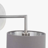 Close-up of the Elin wall light's brushed silver arm and steel grey fabric shade, showing the angular metal joint and mounting detail on a white background.