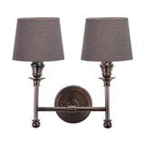 Piero double wall light in antique bronze with two grey handloom fabric shades on a candlestick-style twin arm, shown on a plain white background.