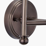 Close-up of the Piero Double Wall Light in antique bronze finish, showing the round wall plate, dual arms, ball finial, and control knob against a plain white background.