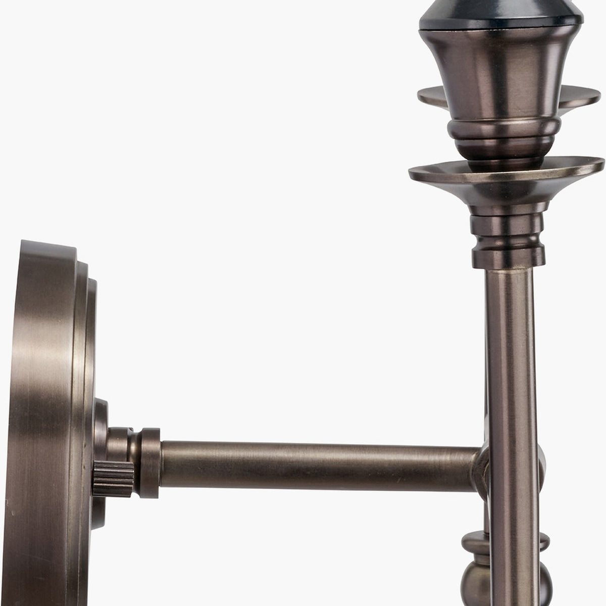 Close-up of the Piero Antique Bronze Double Wall Light showing the metal wall backplate, adjustable arm, and candle-style holders against a plain white background.
