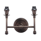 Piero Antique Bronze Double Wall Light, 21cm, with two upward-facing candle-style arms on a round wall-mounted backplate, traditional metal design, shown on a plain white background.