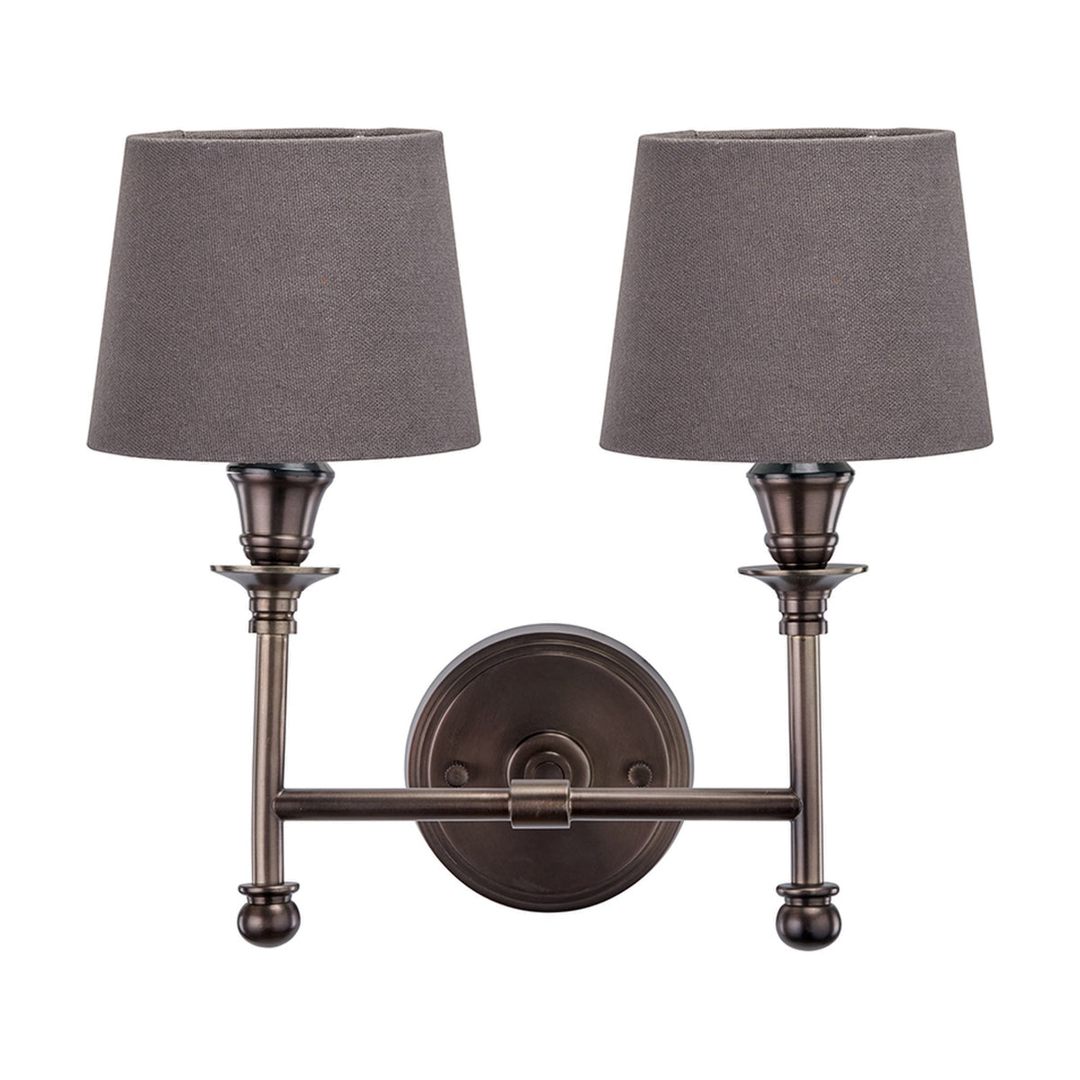 Piero Antique Bronze Double Wall Light with two grey tapered fabric shades on curved arms, joined at a round wall-mounted base, shown on a plain white background.