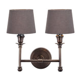 Piero Antique Bronze Double Wall Light with two tapered grey fabric shades on a curved metal arm and round backplate, shown on a plain white background.