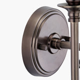 Close-up of the Piero Antique Bronze Double Wall Light, 21cm, showing the round backplate, metal arm, and ribbed knob details in a warm bronze finish against a plain white background.