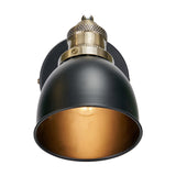 Augusto Black & Gold Task Wall Light with a matte black dome shade, antique brass knurled fitting, and gold-toned interior reflecting the bulb, shown on a white background.