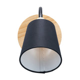 Juna Black Metal & Wood Wall Light with round wooden backplate, black gooseneck arm and tapered black fabric shade on a plain white background.