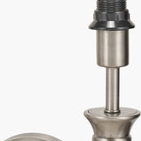 Close-up of the Salvatore wall light's antique silver metal fitting, showing the threaded socket, black cap, and turned column detail against a plain white background.