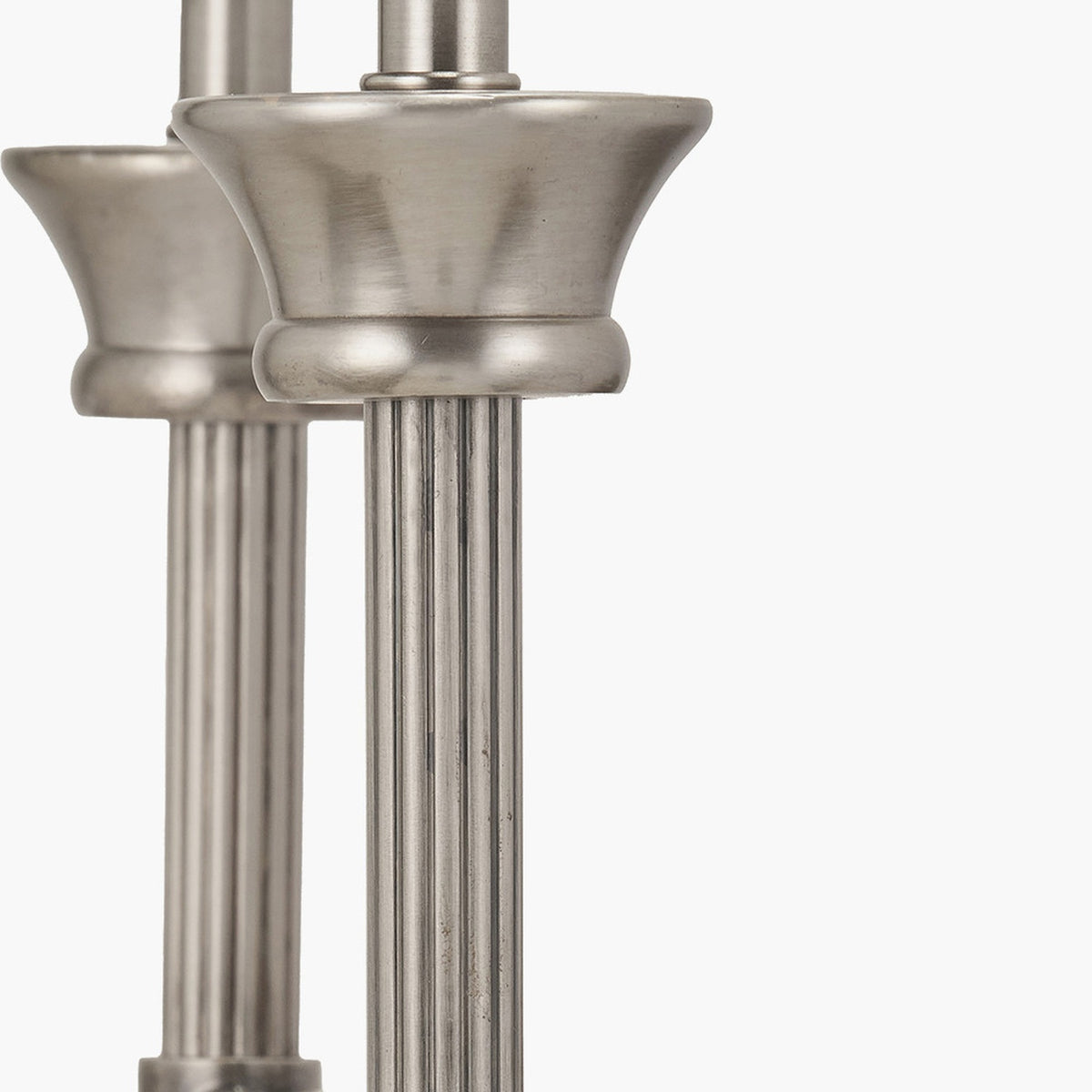Close-up of the Salvatore double wall light in antique silver metal, showing reeded stems and cup-shaped bases against a plain white background.