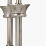 Close-up of the Salvatore double wall light in antique silver metal, showing reeded stems and cup-shaped bases against a plain white background.