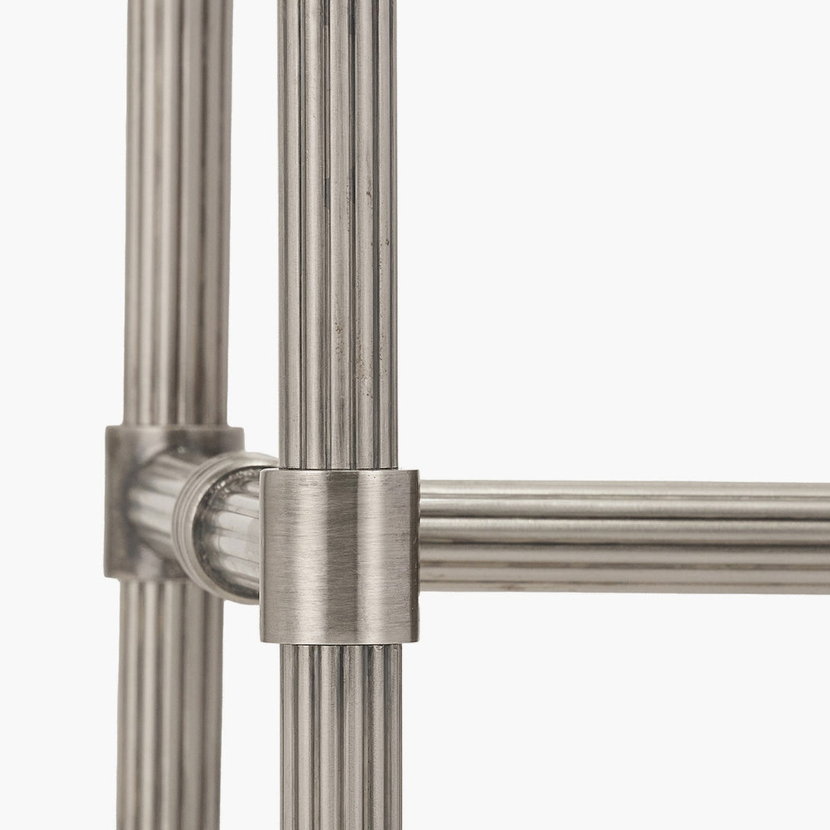 Close-up of the Salvatore wall light's fluted antique silver metal rods and joint bracket, showing the ribbed detailing and connector against a plain white background.