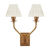 Tatiana antique brass double wall light with two upward-curving arms and pleated cream silk mix shades, shown on a plain white background.