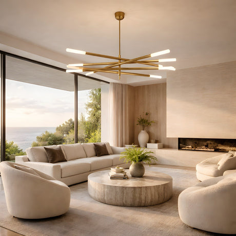 A modern living room with white sofas, round chairs, a large round coffee table, built-in fireplace, floor-to-ceiling ocean-view windows, and an Aurelian LED Layered Arms Alabaster Chandelier in brushed brass & soft white overhead.