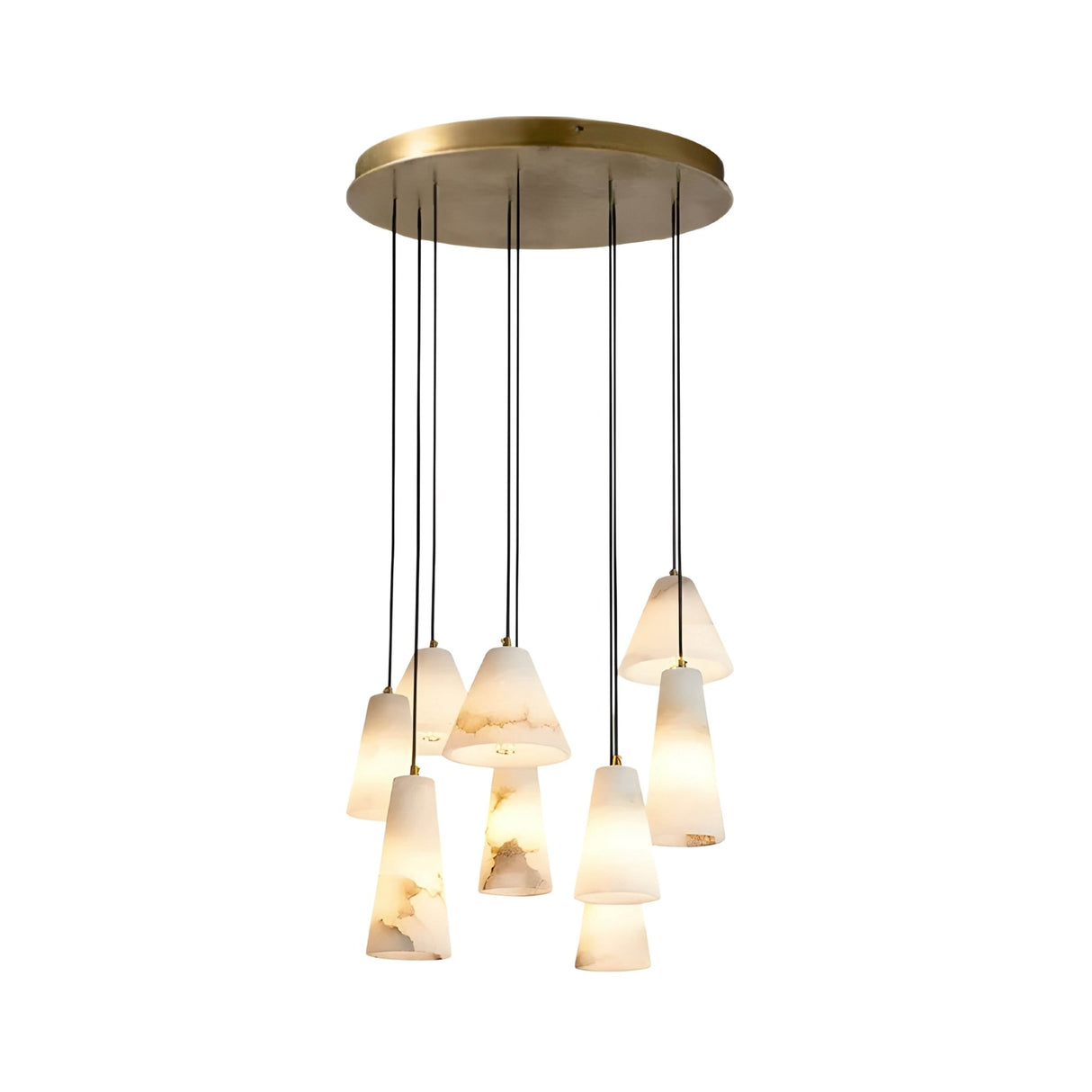 The Sorrelis 9 Light Cluster Alabaster Pendant Light features nine soft white cone-shaped lampshades suspended at different lengths from a round, brushed brass mount, providing a warm, diffused glow.