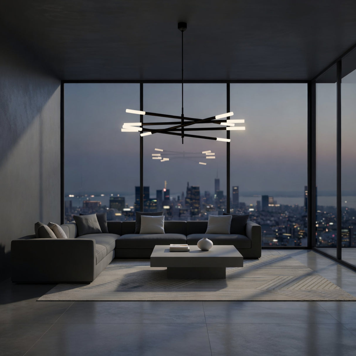 A modern living room with a large gray sectional, low rectangular coffee table, and the Aurelian LED Layered Arms Alabaster Chandelier in Matte Black & Soft White, with floor-to-ceiling windows showcasing a city skyline at dusk.