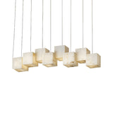 The Elmyra 8 Light Linear Alabaster Bar Pendant Light in Soft White features eight illuminated cube-shaped pendants suspended in a row, crafted from translucent alabaster for a warm, gentle glow against any backdrop.
