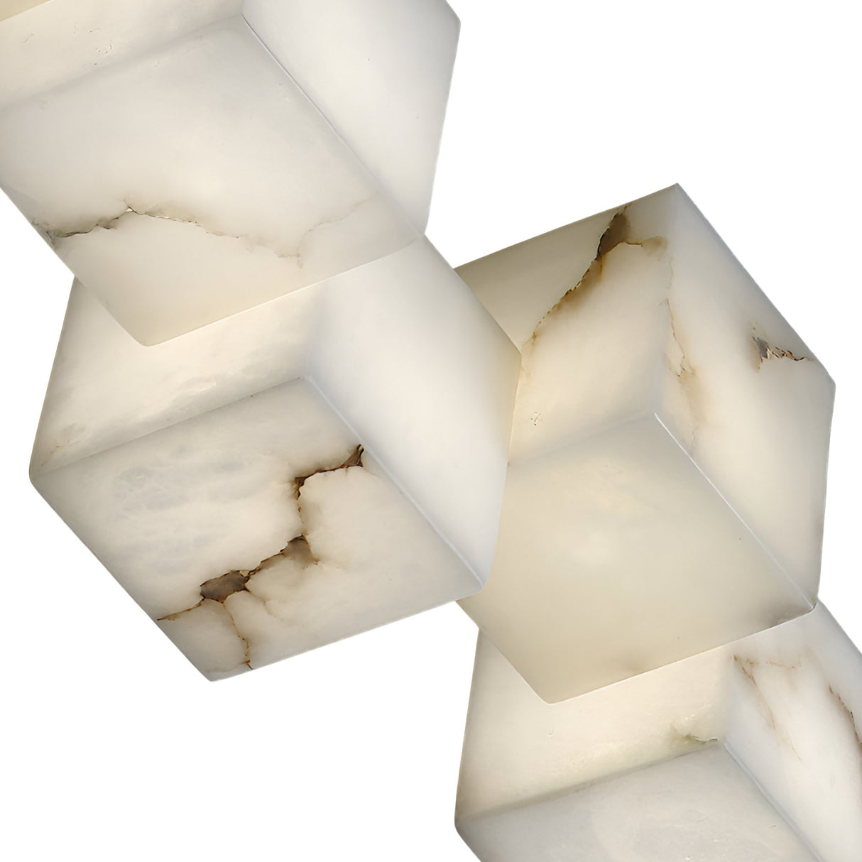 Three smooth, marble-like white cubes with brown veining, inspired by the Elmyra 10 Light Linear Alabaster Bar Pendant Light in Soft White, are stacked diagonally against a white background and appear to be made of translucent stone.