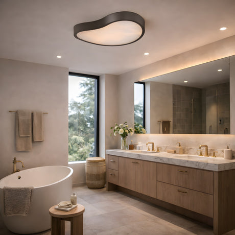 Modern bathroom featuring a freestanding tub, wooden stool, double vanity with marble countertop, large mirror, gold fixtures, and the Marea Alabaster LED Semi-Flush Ceiling Light – Matte Black. Large window offers tree views and natural light.