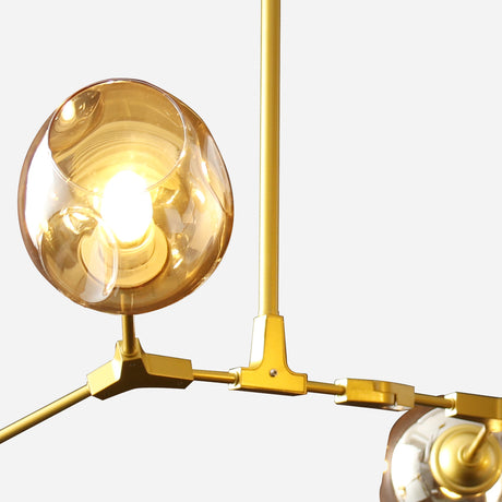 The Tree 6 Light Suspension - Gold features a contemporary design with golden metal arms and spherical amber glass shades enclosing brilliant bulbs. This sophisticated lighting fixture boasts intersecting rods that form a geometric pattern, making it an ideal choice for any modern interior lighting arrangement.