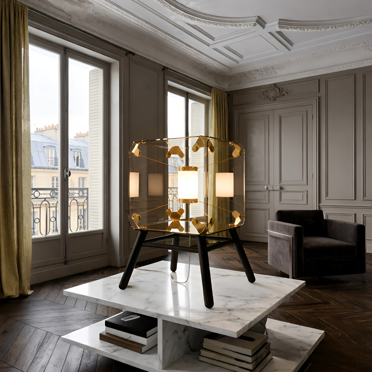 Niori Qbic LED Small Floor Lamp in clear glass with brass brackets and black metal legs, lit on a marble table in a Parisian living room.