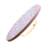 The Pin LED Wall Light showcases modern minimalism with its round, terrazzo-patterned design. A soft ambient halo casts a warm glow, accentuating the pink and blue speckles on a pristine white surface.